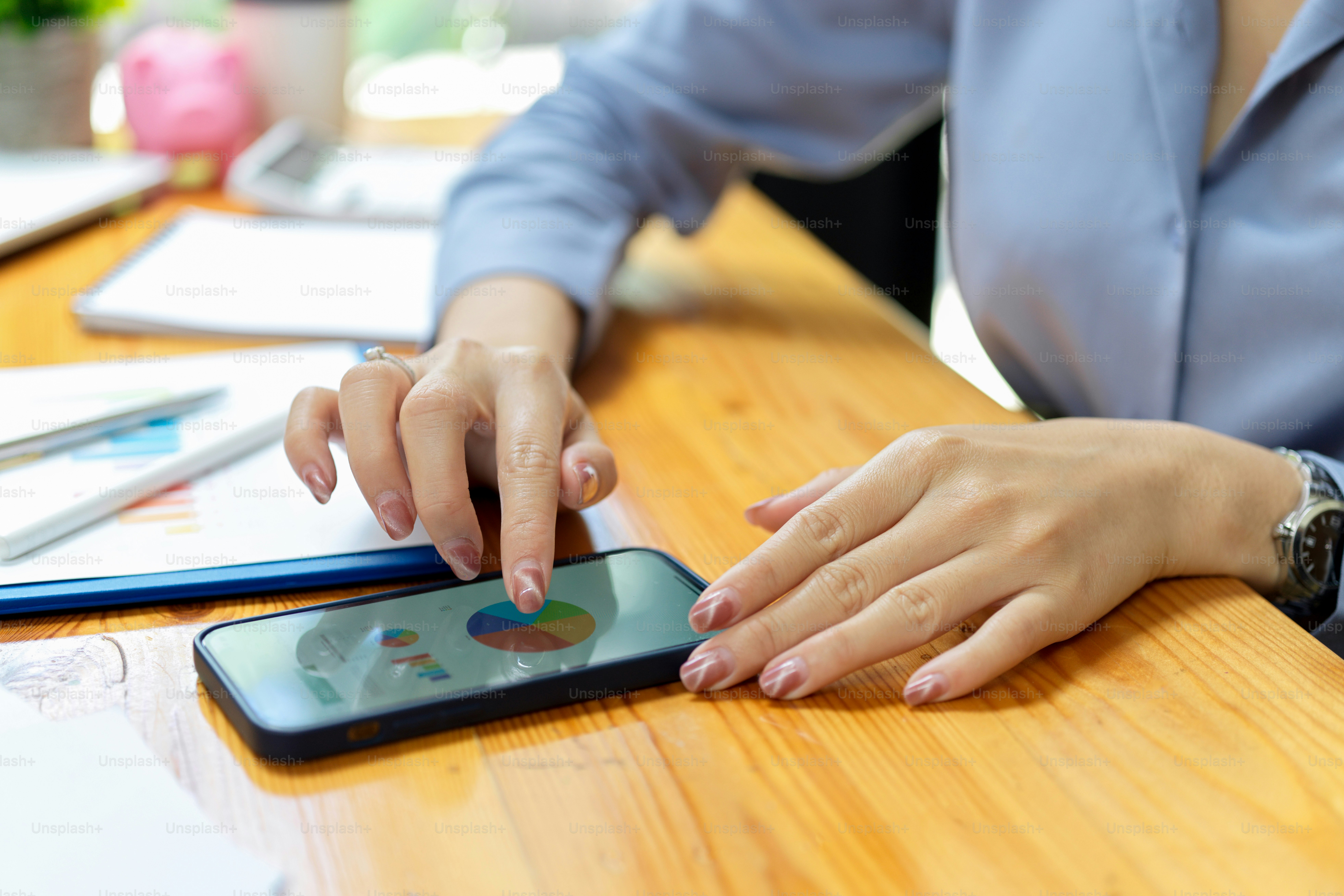 Businesswoman making financial sale report graph for business presentation on smartphone