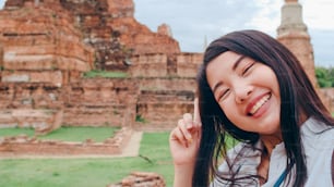 Close-up Young Asian backpacker blogger woman casual look camera video call on smartphone share live online for audience travel together at pagoda old city, Lifestyle tourist travel holiday concept.