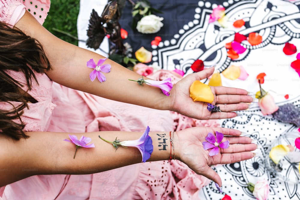 Young mexican woman with flowers on her arms sitting on her legs for holistic session in Mexico