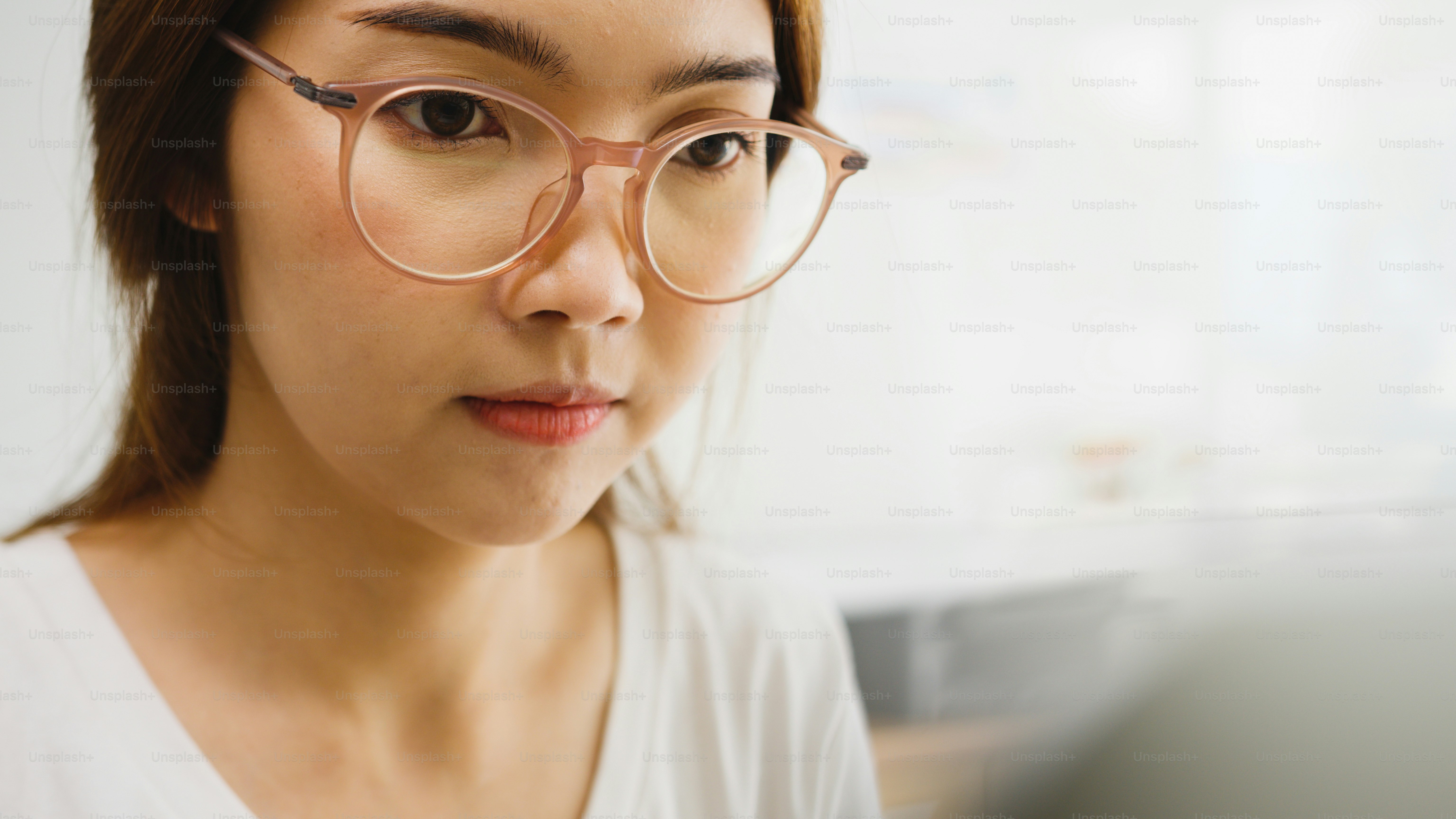 Freelance young Asia businesswoman casual wear using laptop working in living room at home. Working from home, remotely work, self isolation, social distancing, quarantine for corona virus prevention.