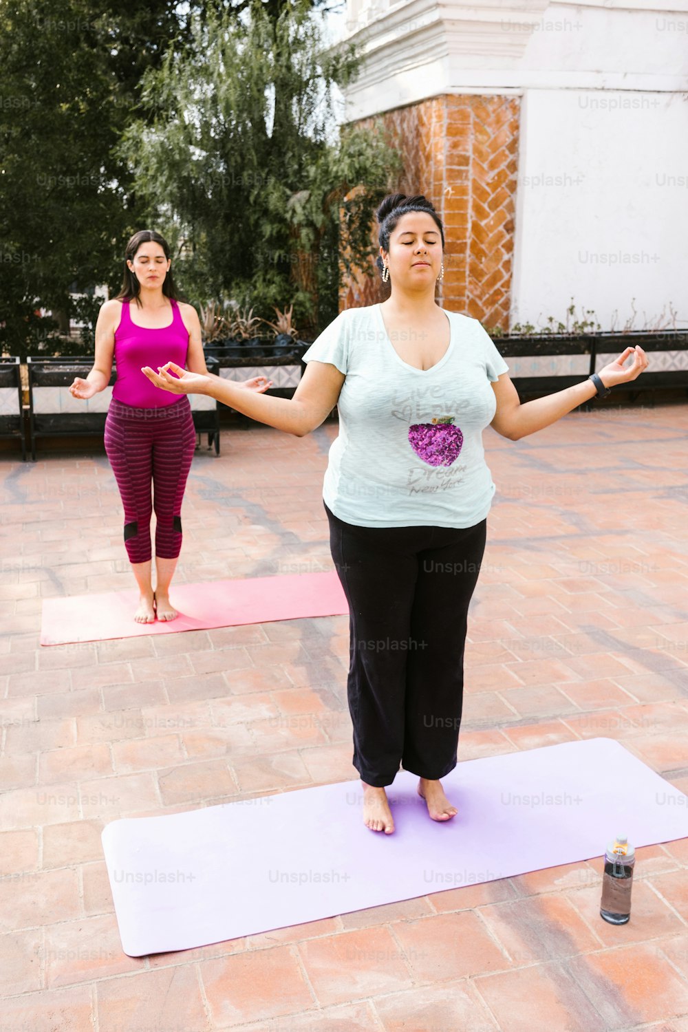 Young latin women standing with closed eyes doing meditation on the terrace in Mexico City