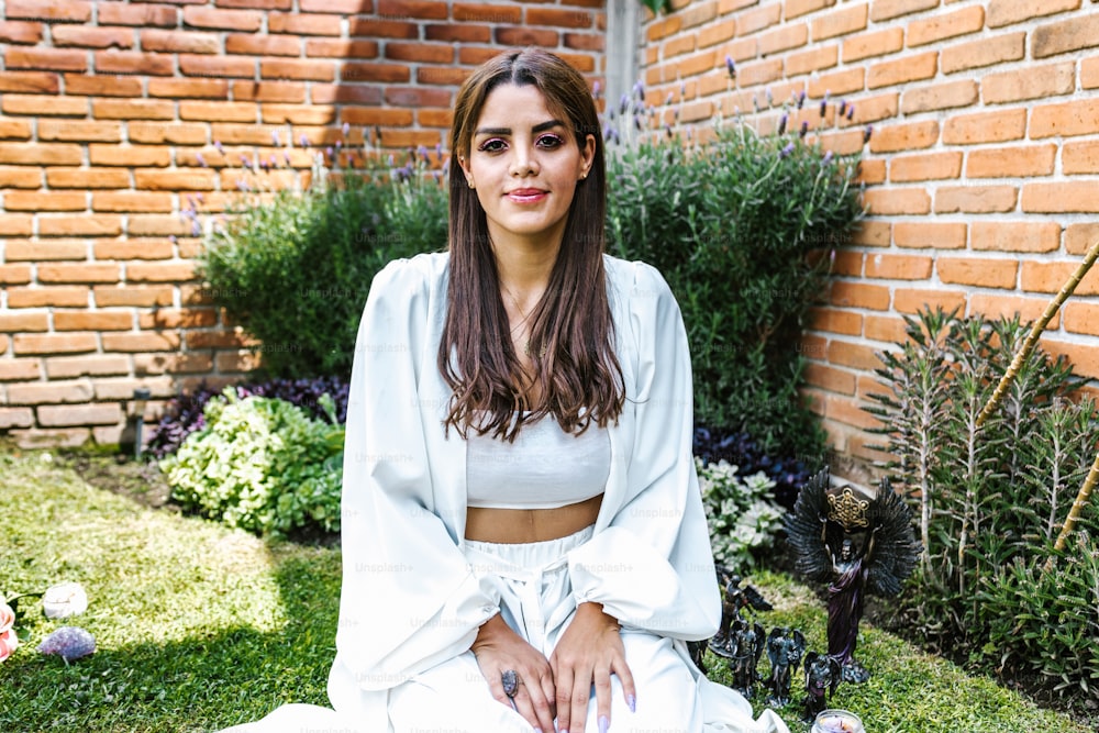 Portrait of latin girl specialist in holistic therapy sitting in the garden in Mexico City