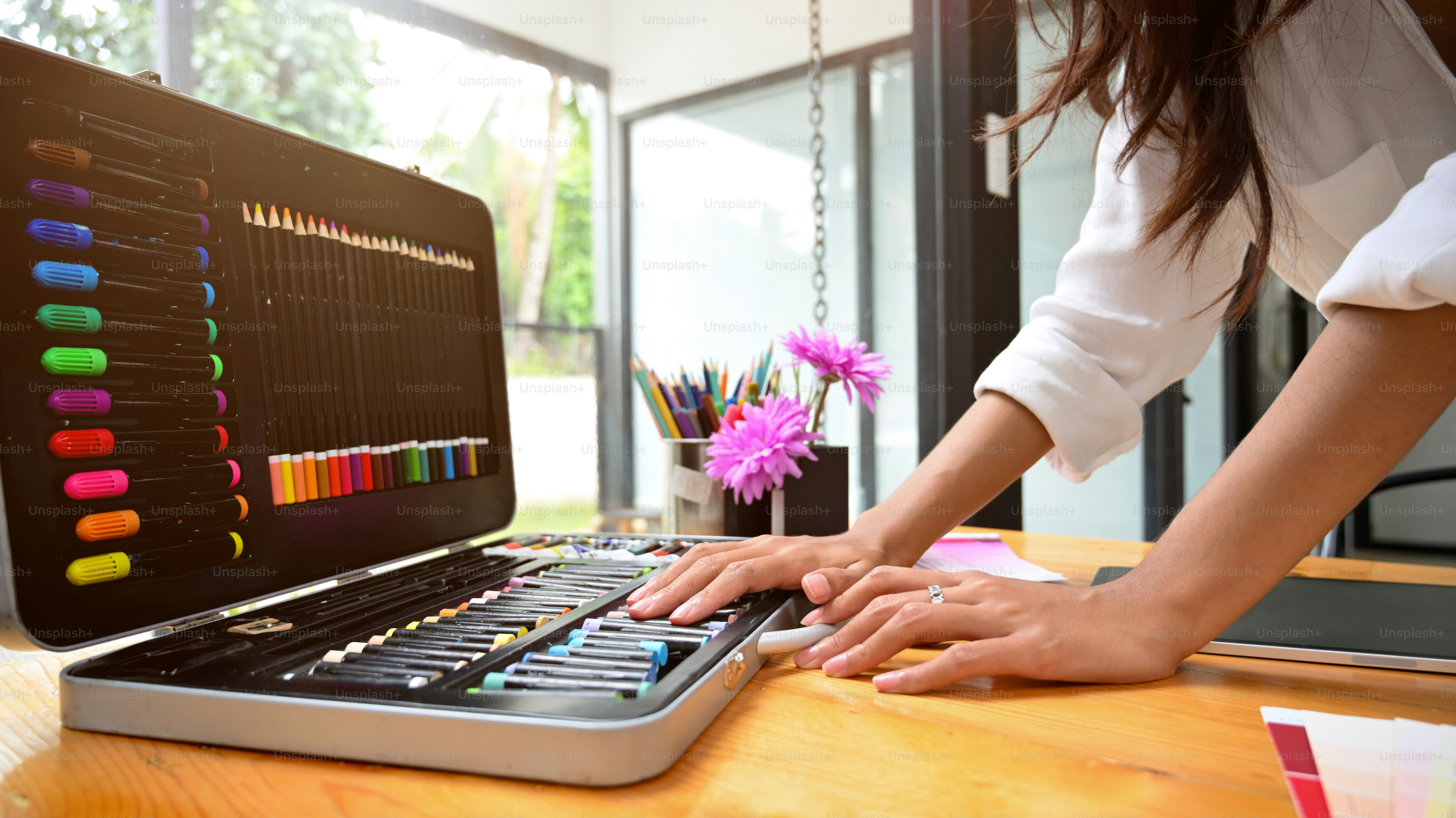 Closeup, Female selecting colour for her art work with art set, beginner art student, female painter