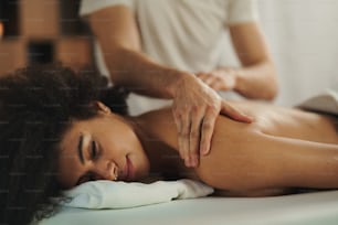 Young woman having relaxing back massage at the spa.