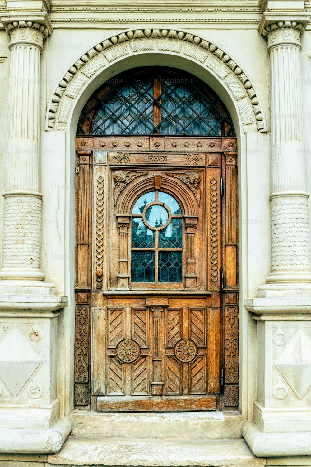 Old wooden door of a house in the historic quarter of the city. Background and texture of carved brown polished wood