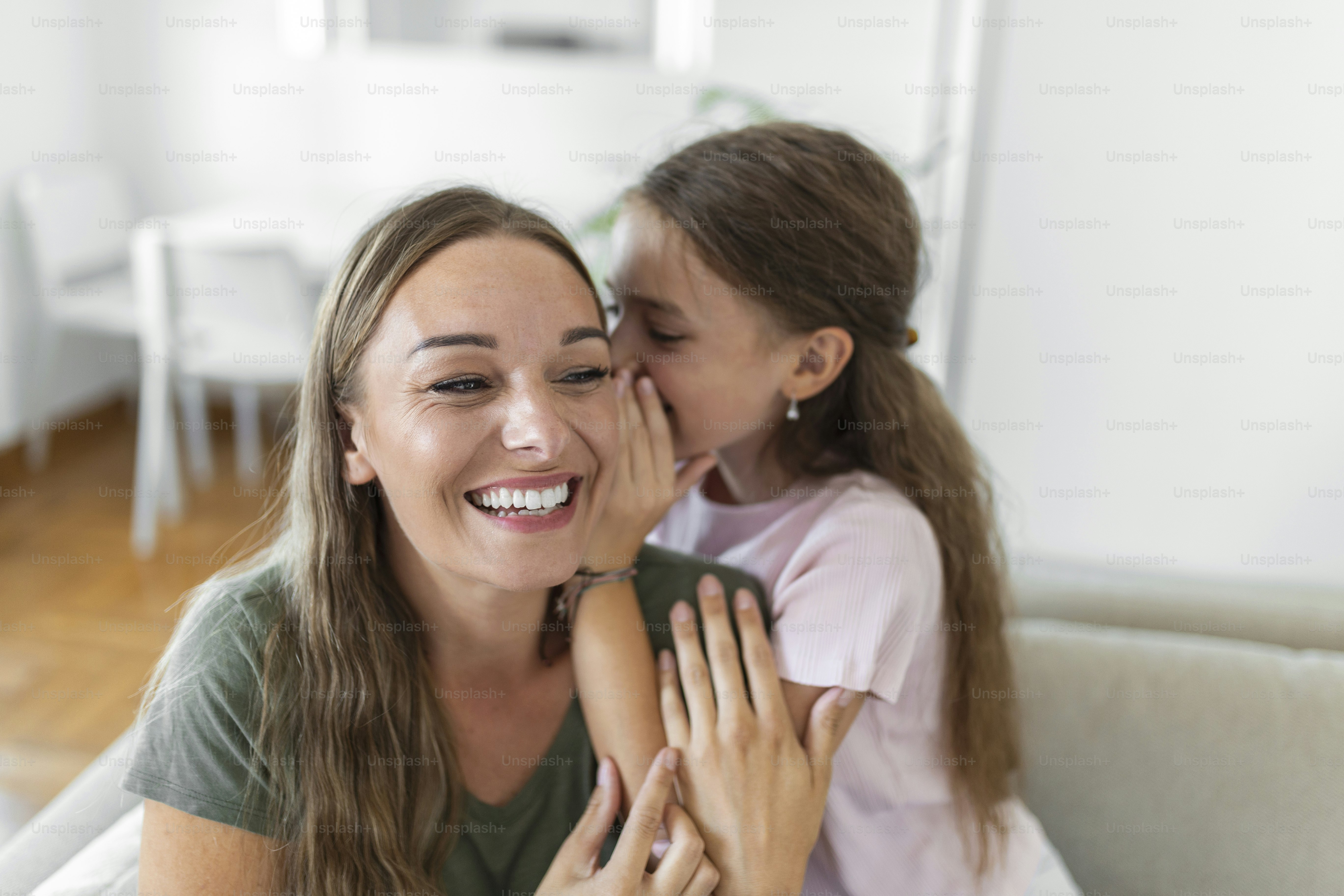 Close up image amazed mother hears incredible news from little daughter, kid girl share secret telling something interesting while mom open mouth feels surprised, trust, confidant person, fun concept