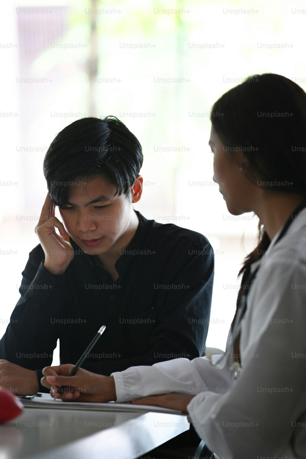 Doctor explaining medical informations and diagnosis to man patient.