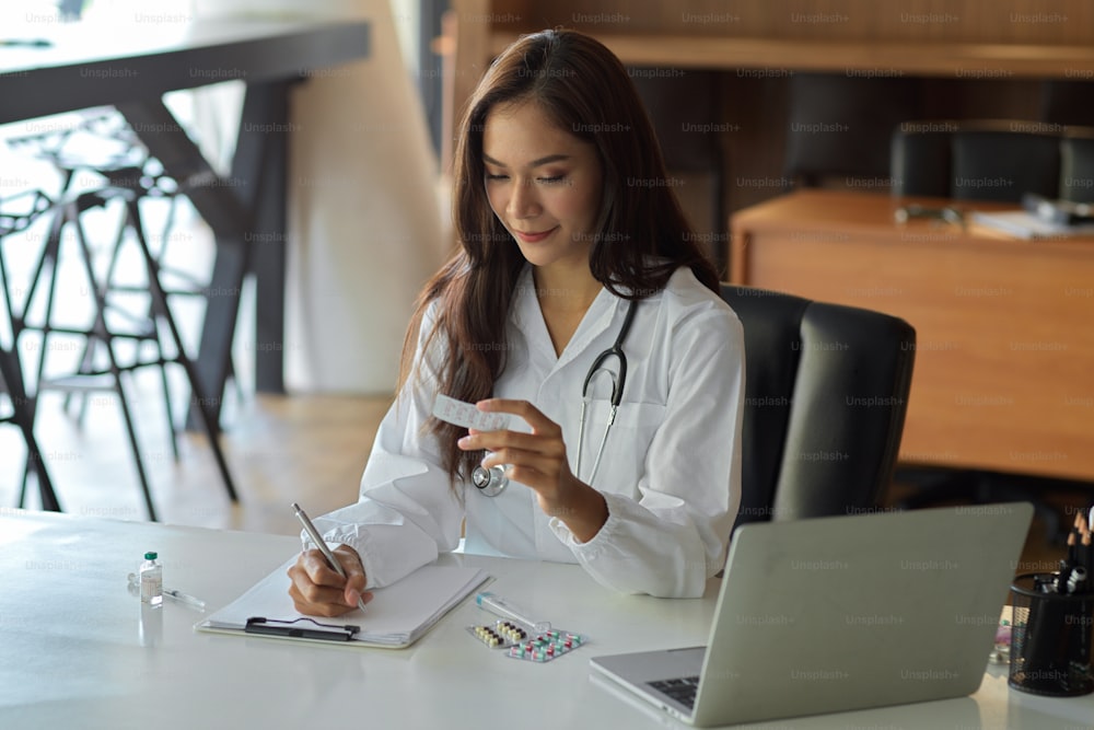 Attractive female pharmacist giving instructions for a patient's medication prescription.