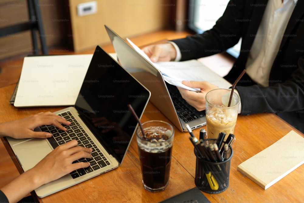 Business concept. Business people busy work in office. Business women typing on laptop computer, businessman look at paperworks