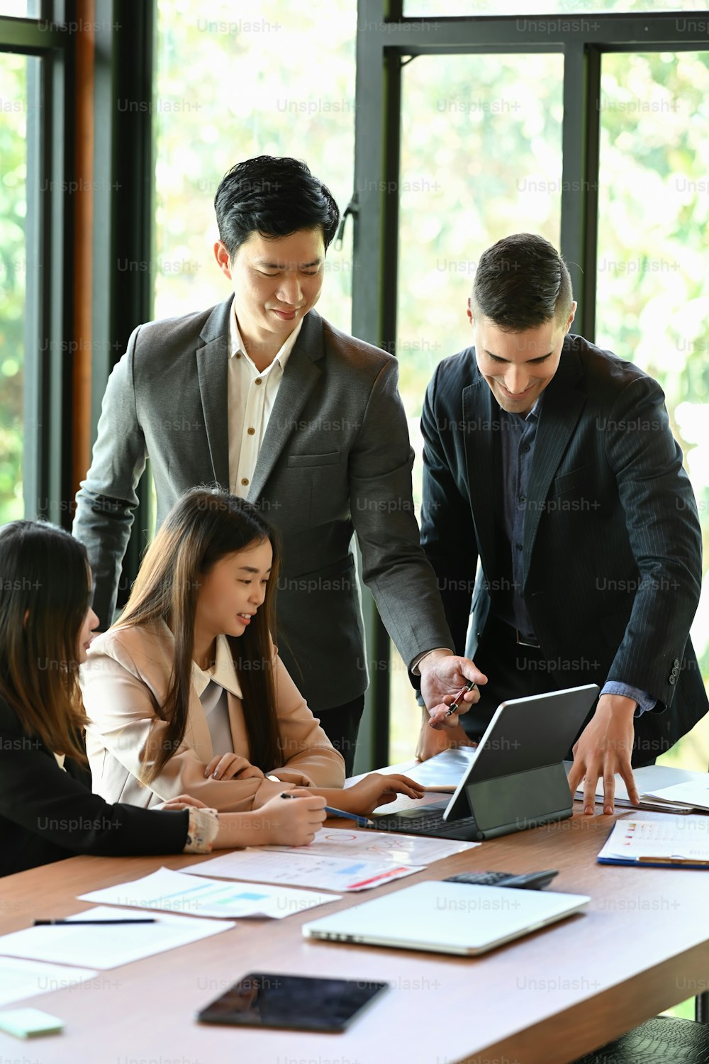 Group of business people sharing their ideas and discussing business strategy at meeting room.