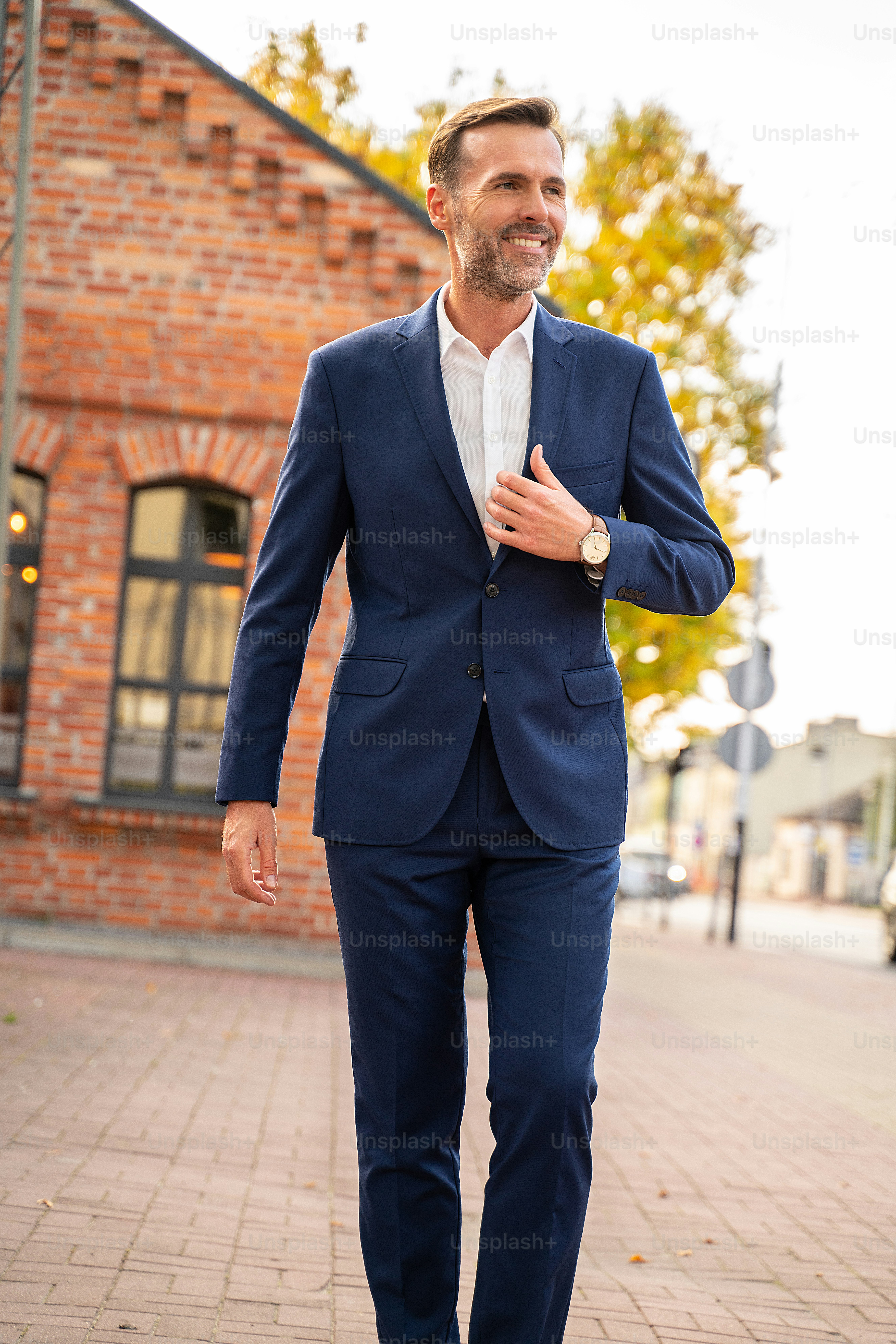 Stylish handsome man with beard, wearing elegant suit outdoor on the city  street. Businessman after work. photo  Business Image on Unsplash