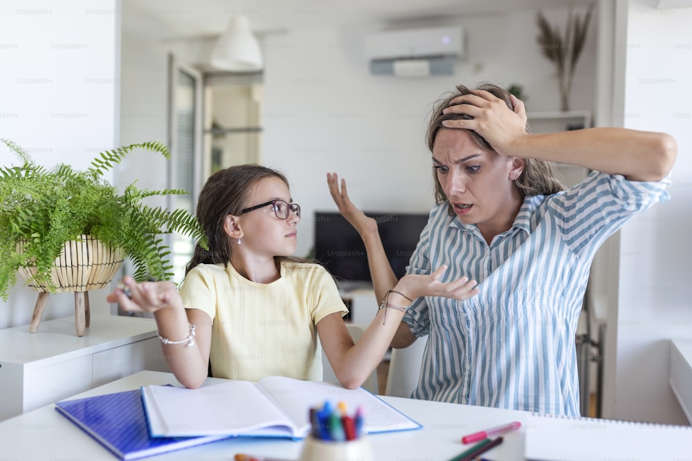 Mother Becoming Frustrated With daughter Whilst Doing Homework. Mom makes the best teacher ever. Mother scolds a child for poor schooling and homework at home