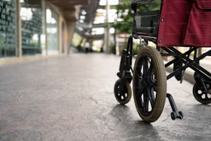 Empty wheelchair at hallway in hospital. Medical equipment in hospital for assistance handicapped people.
