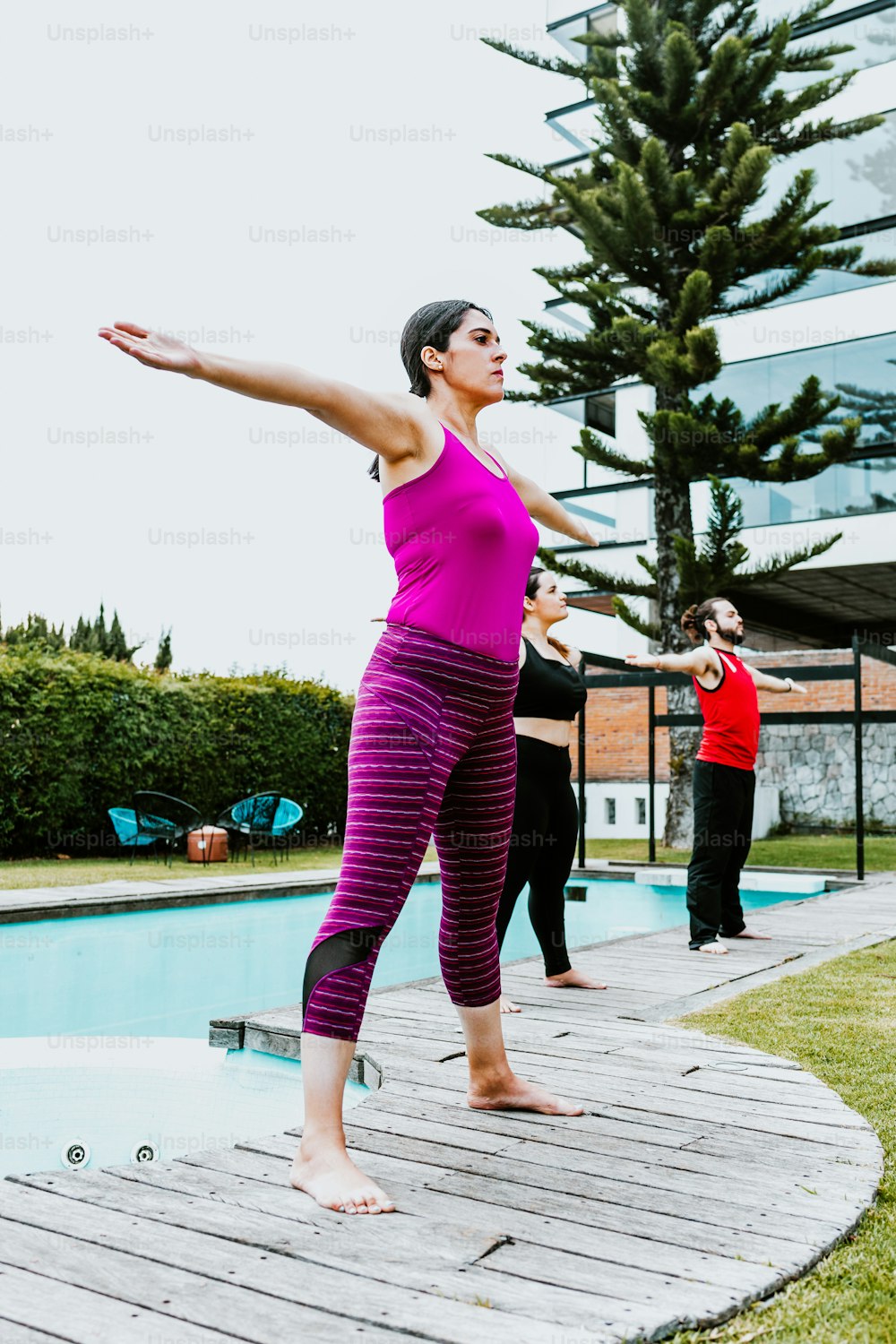 Middle aged latin woman standing in yoga session stretching arms in Mexico City