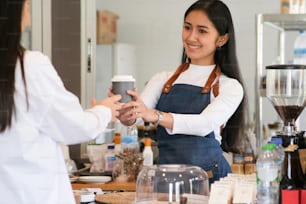 Small Business and Owner Business Concept. Young owner of coffee cafe service customer.