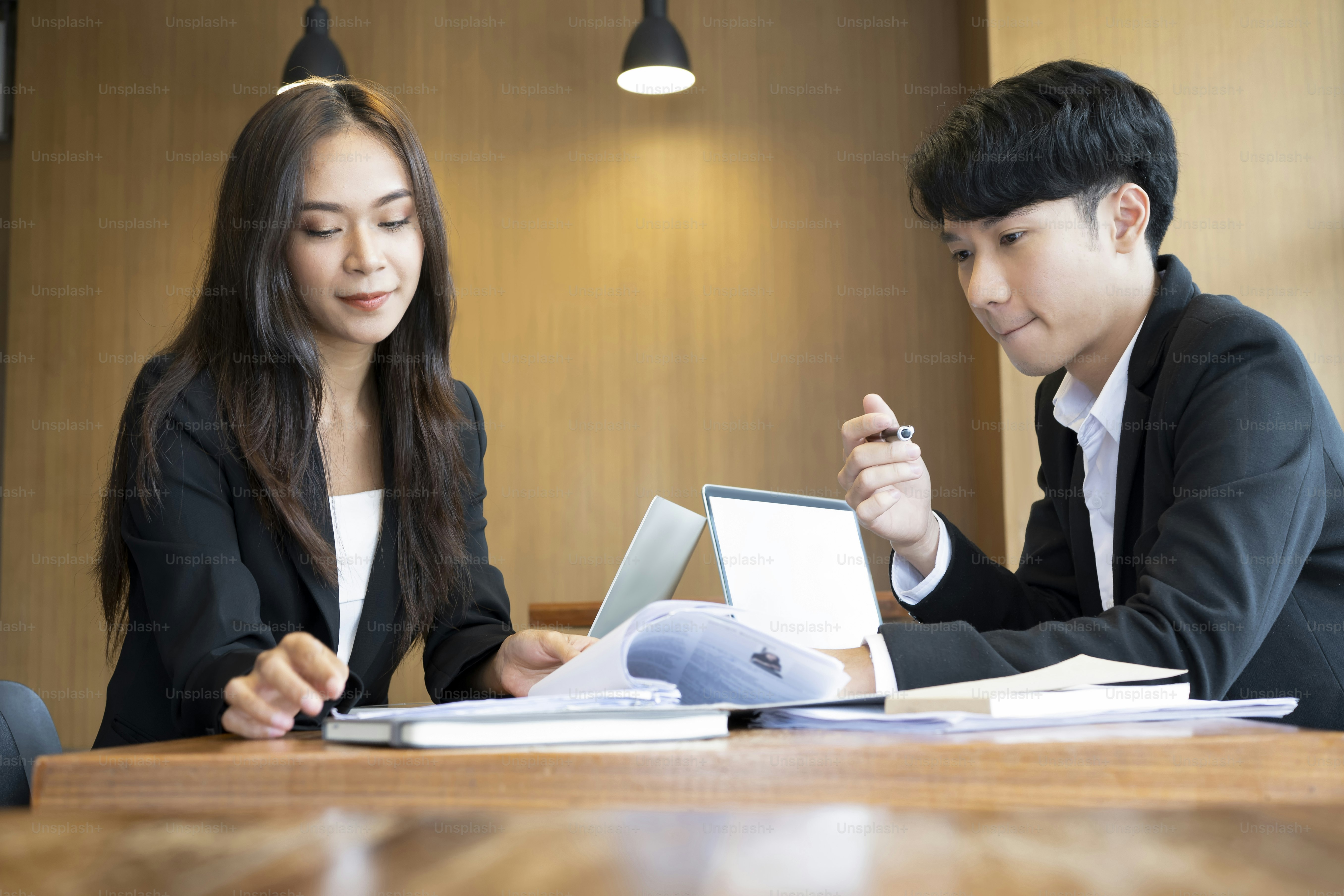 Two young business colleagues discussing new ideas together.