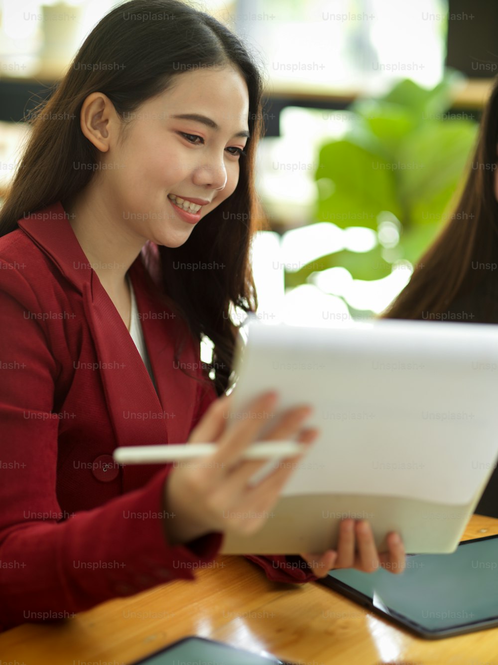 Young asian businesswomen working with statistics and checking financial report papers in a modern office