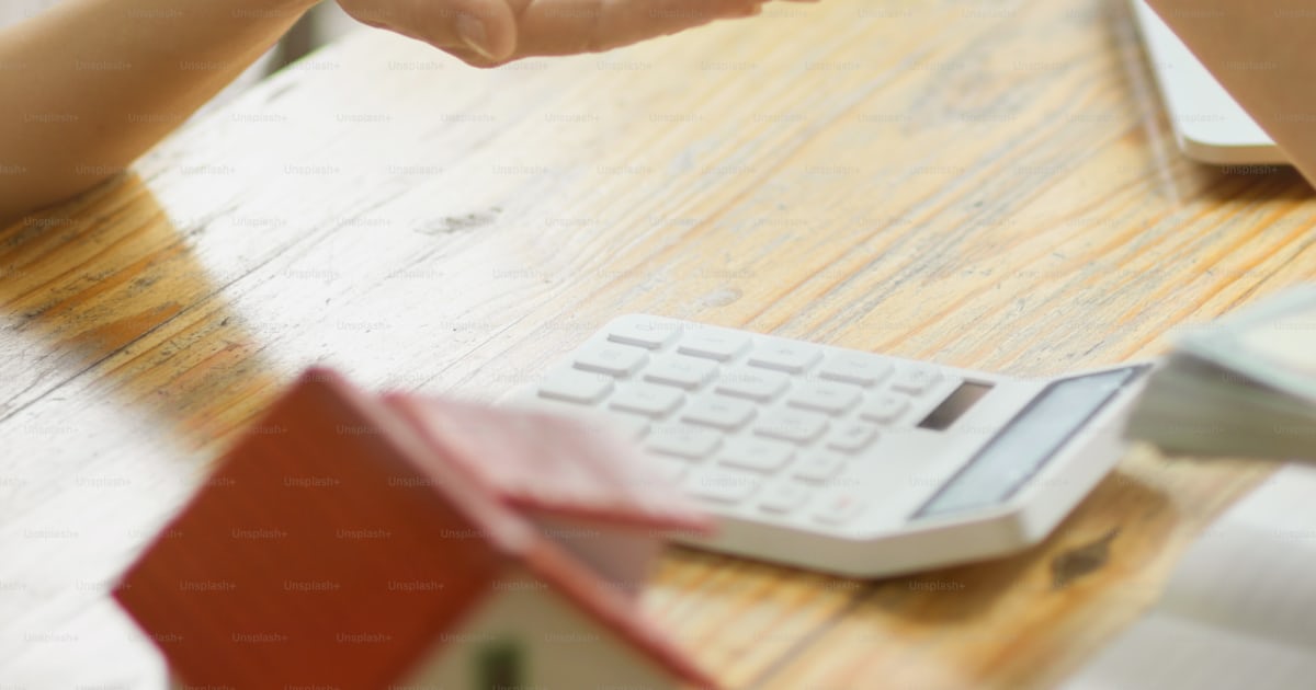 Close-up image of a real estate agent handing over a house key to a new ...