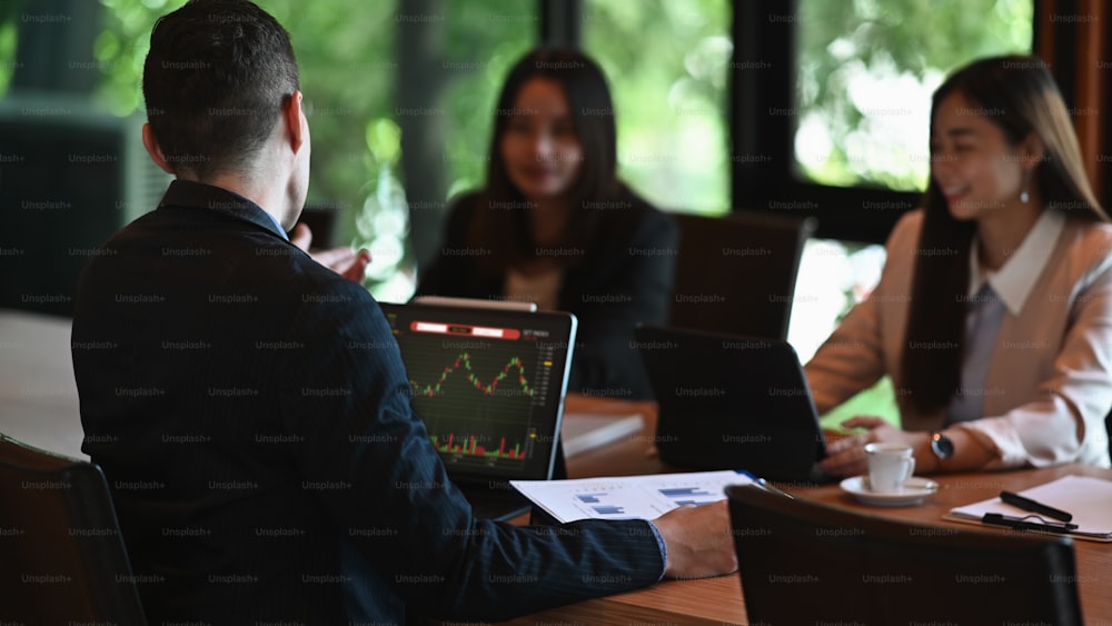 Group of successful businesspeople meeting in modern boardroom.