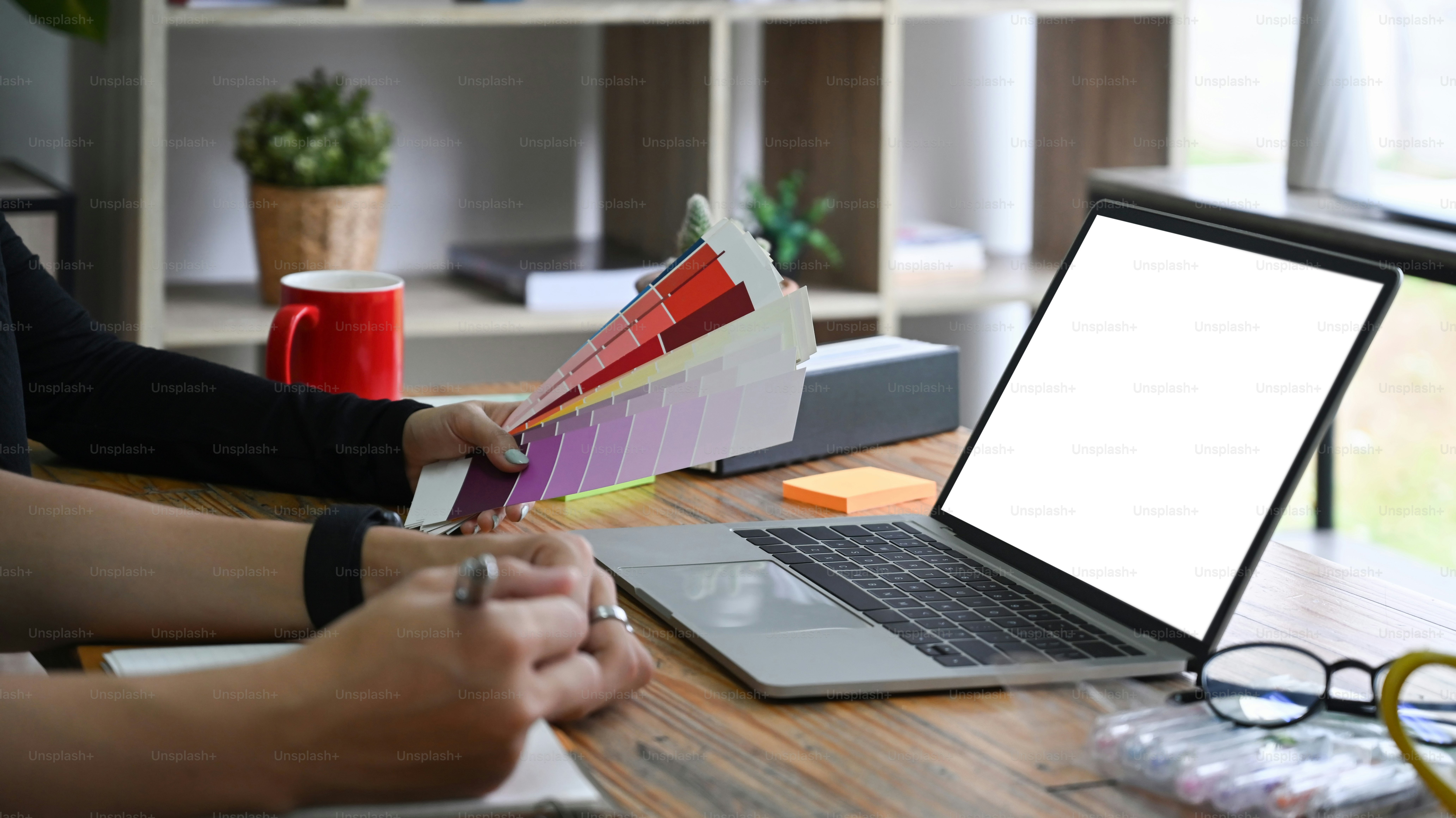 Cropped shot group of designer working with laptop computer in office.