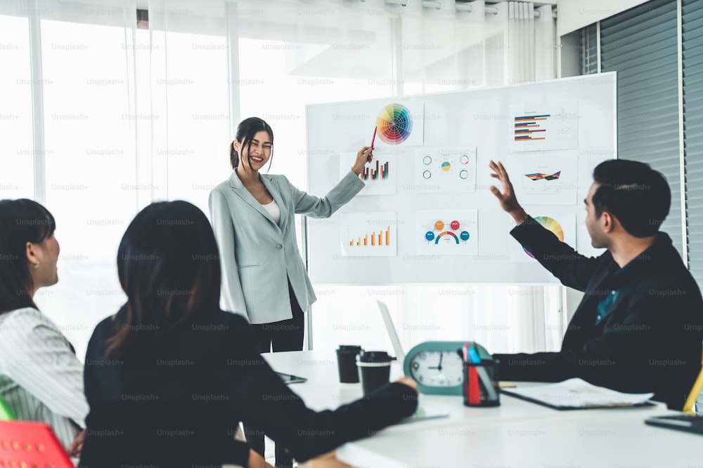 Business people proficiently discuss work project while sitting in circle . Corporate business team collaboration concept .