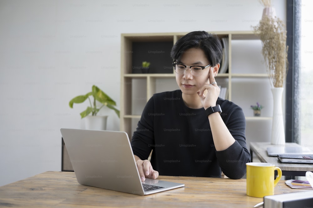 Man working with computer laptop at his office room.