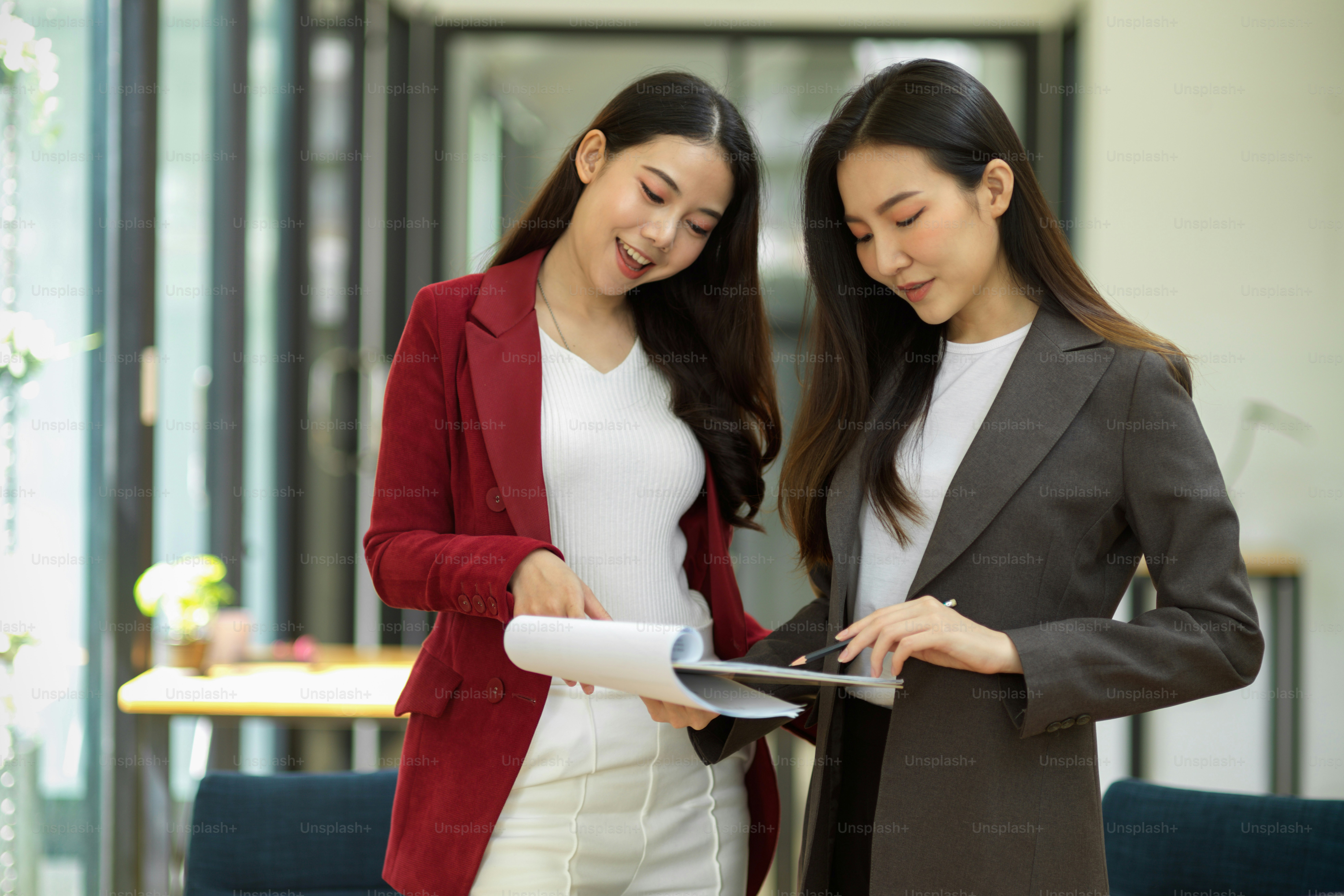 Attractive businesswoman gives feedback to her employees, discusses, talks, and mentors them in the office. businesswomen working together.