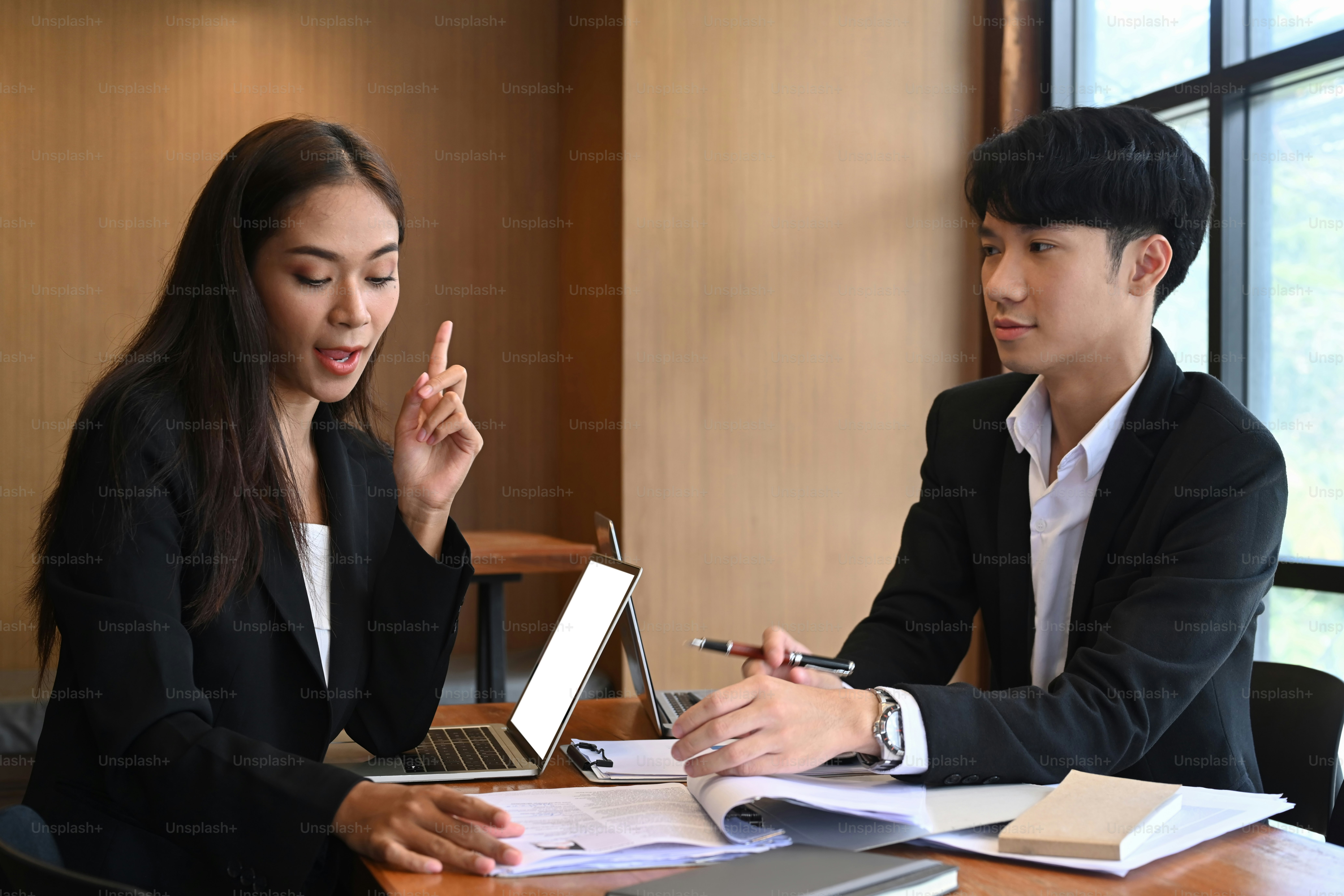 Team of human resources department reading resume document of an employee candidate together.
