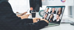 Business people in video call meeting proficiently discuss business plan in office and virual workplace . Telework conference call using smart video technology to communicate colleague .