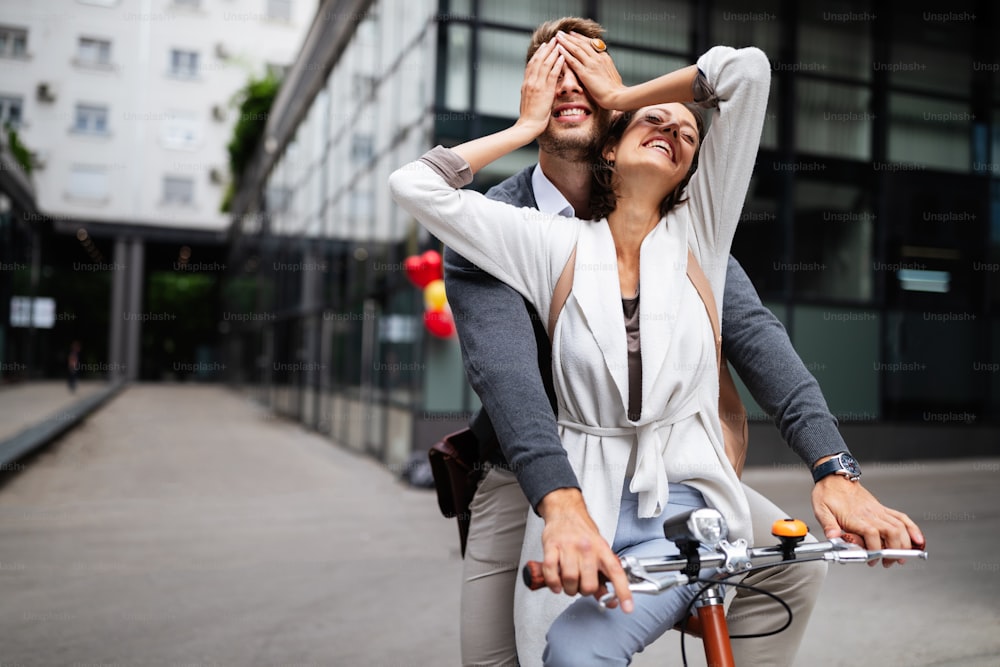 Beautiful happy couple in love on bicycle in the city having fun