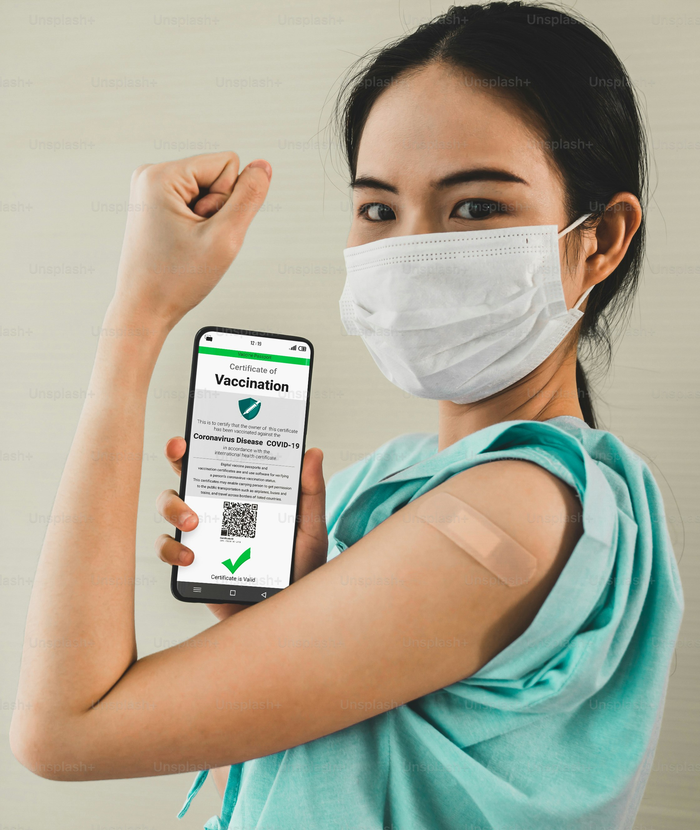 Young Asian woman shows vaccine passport on mobile phone to validate travel permission by the digital document