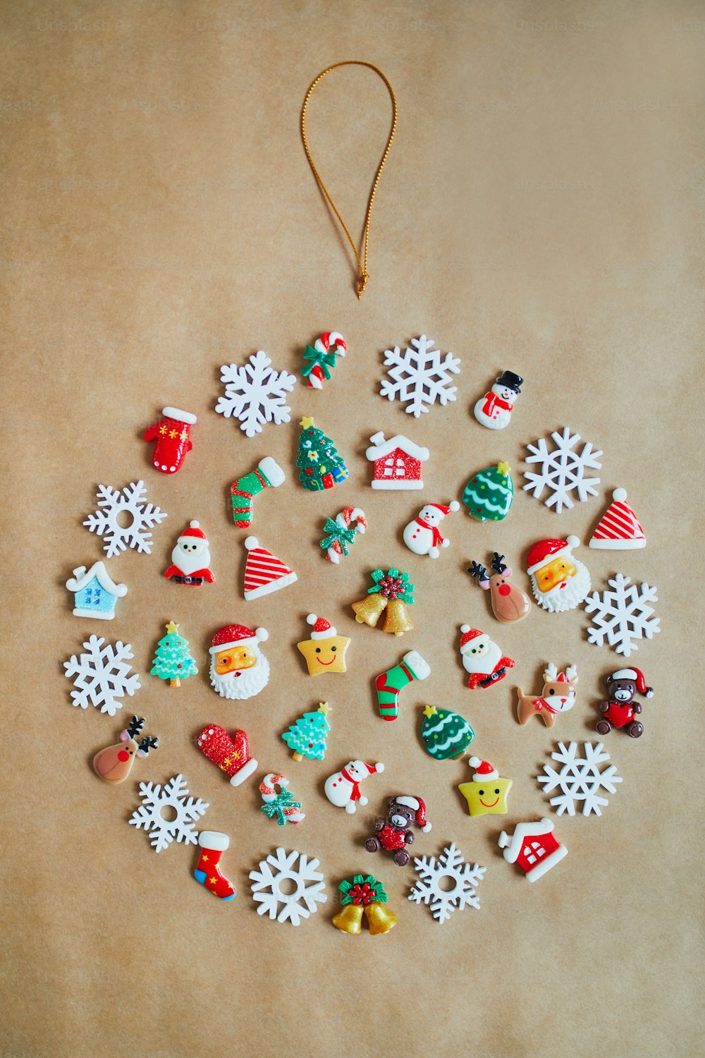 Christmas decorations flat lay. Bauble made from small figurines with New Year theme. Seasonal holidays celebration concept