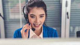 Businesswoman wearing headset working actively in office . Call center, telemarketing, customer support agent provide service on telephone video conference call.