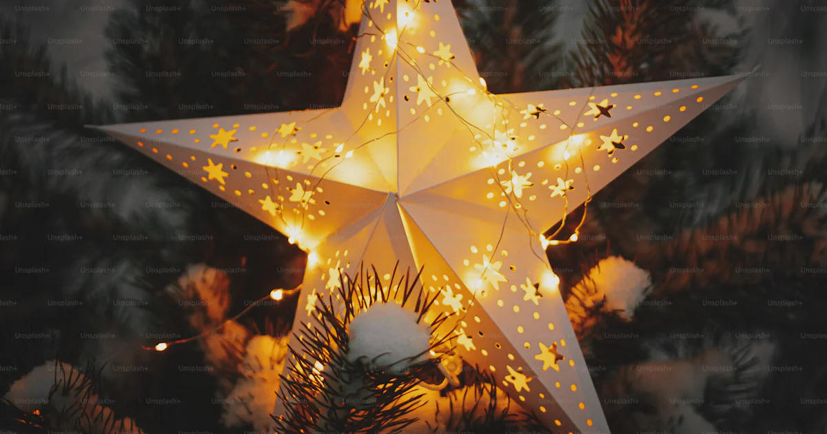 Christmas Rising Star Big Christmas star glowing on snowy pine tree in winter park at night ...