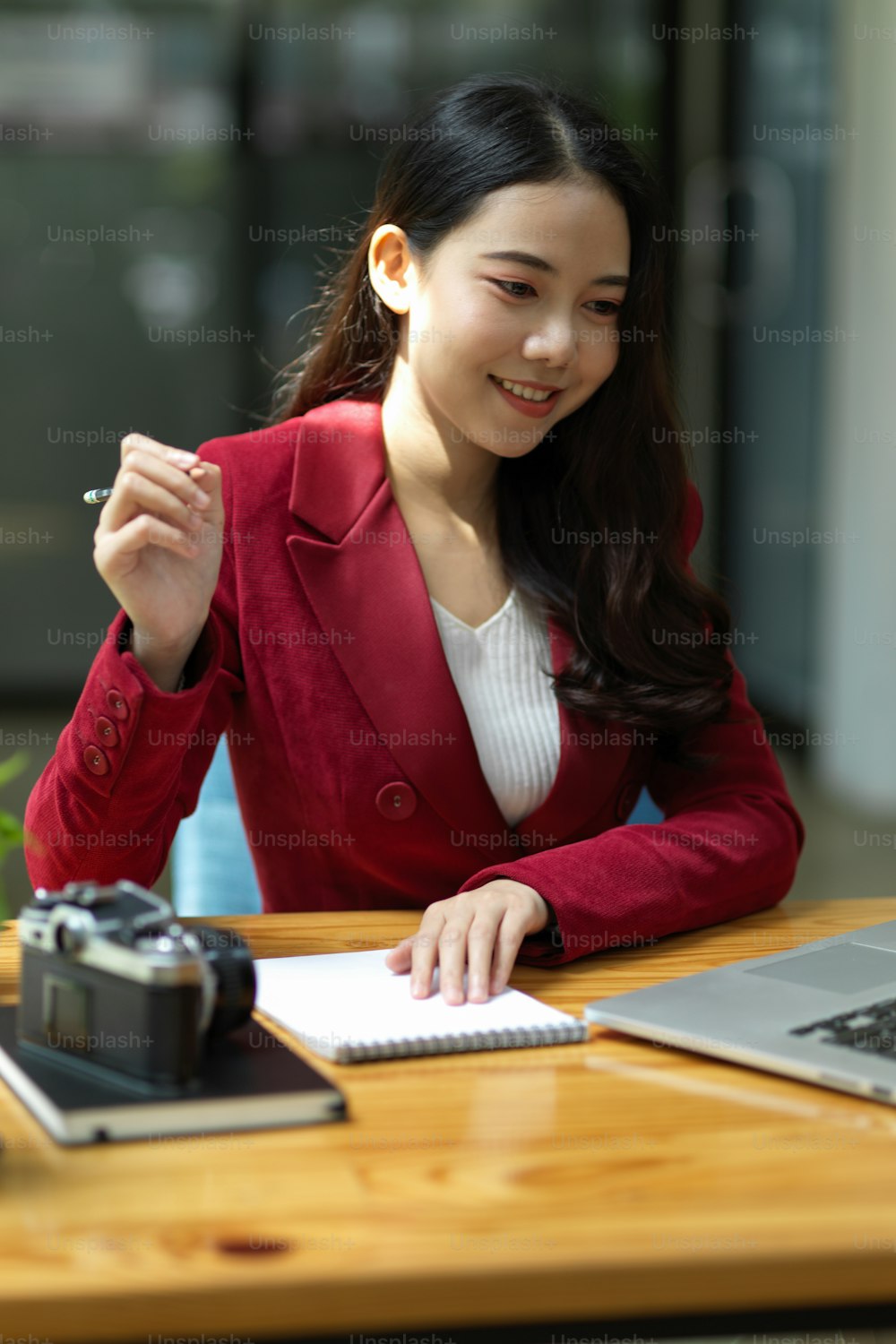 Portrait of confident businesswoman working at her desk looking the information and data on laptop screen.