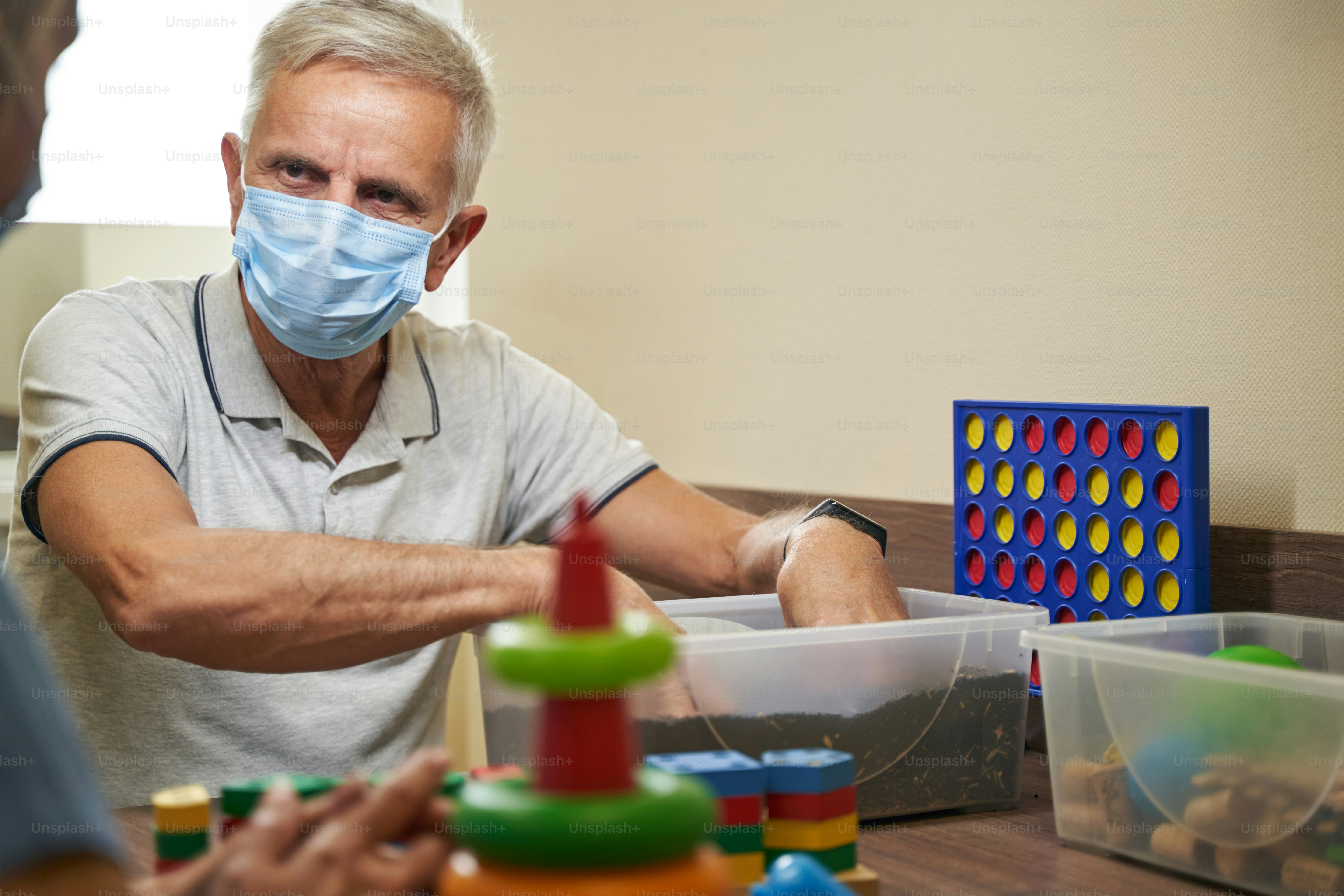 Mature person who has lost memory after stroke doing exercises for recovery of adaptive skills in neurological rehabilitation facility