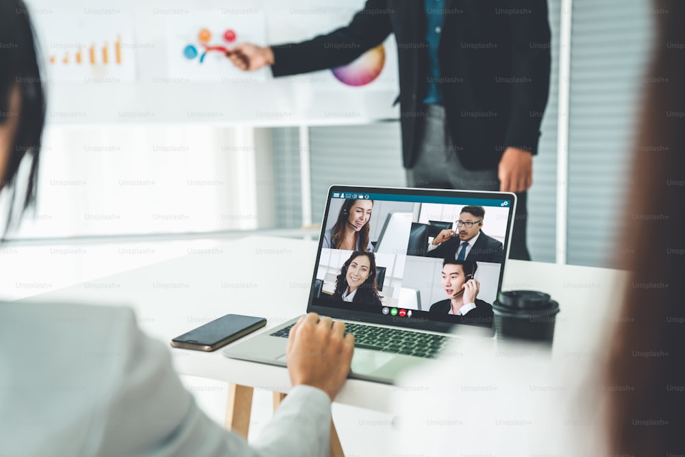 Business people in video call meeting proficiently discuss business plan in office and virual workplace . Telework conference call using smart video technology to communicate colleague .