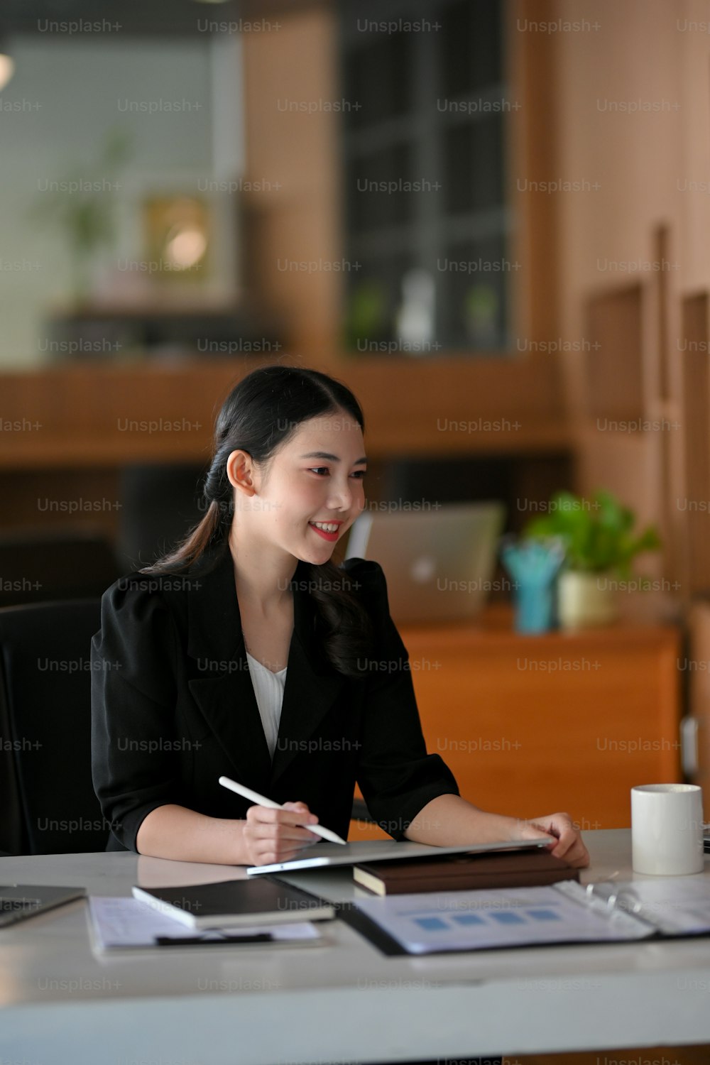 Portrait of Friendly female manager interviews new job candidates in the meeting room. Businesswoman in the  board room