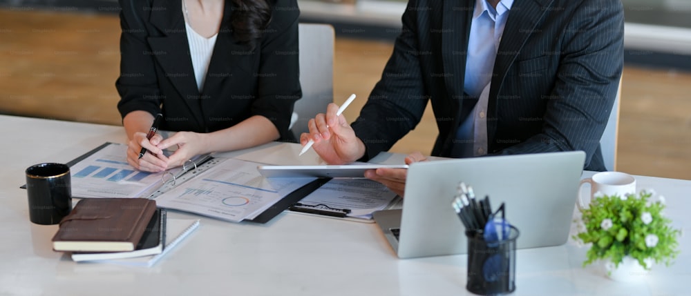 Cropped shot of a businessman in a formal suit at his office discussing a financial contract with his personal professional lawyer.