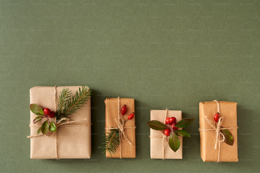 Christmas presents wrapped in ecological recycled paper with wintergreen and spruce - zero-waste concept with copy space