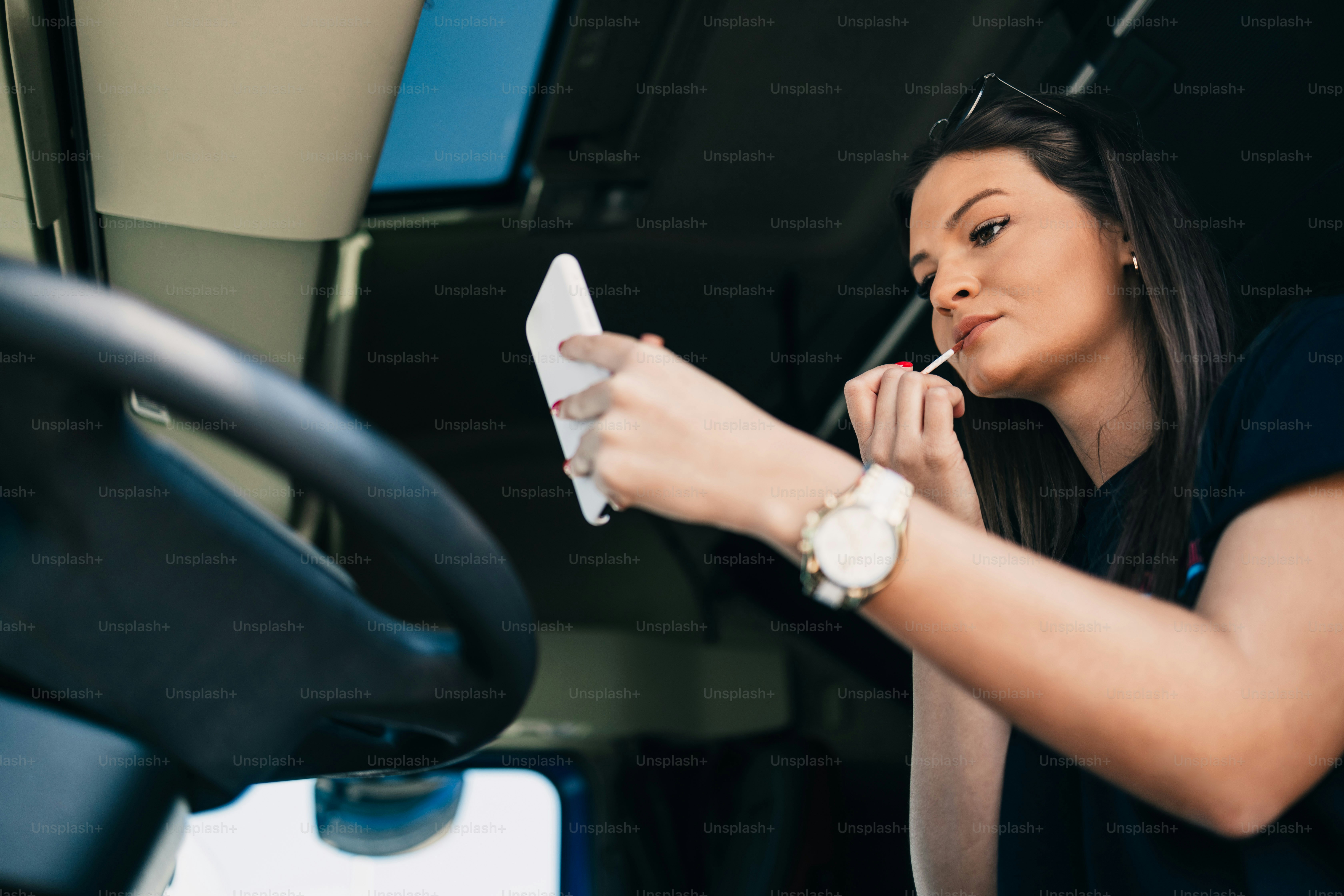 Portrait of beautiful young woman professional truck driver sitting and resting after long drive. Inside of vehicle. People and transportation concept.