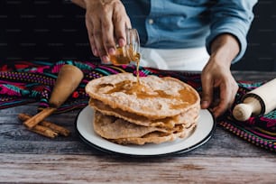 hands of mexican man cooking buñuelos, recipe and ingredients of traditional dessert for Christmas in Mexico