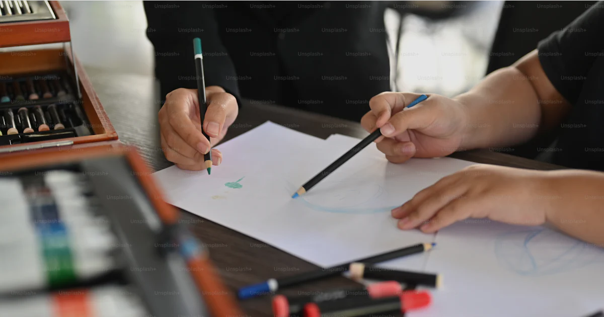 Helper Draw Pic Close up view art teacher helping helping her student drawing. photo ...