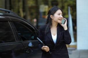 Successful businesswoman on the street while talking on the phone with business client. urban business life concept.
