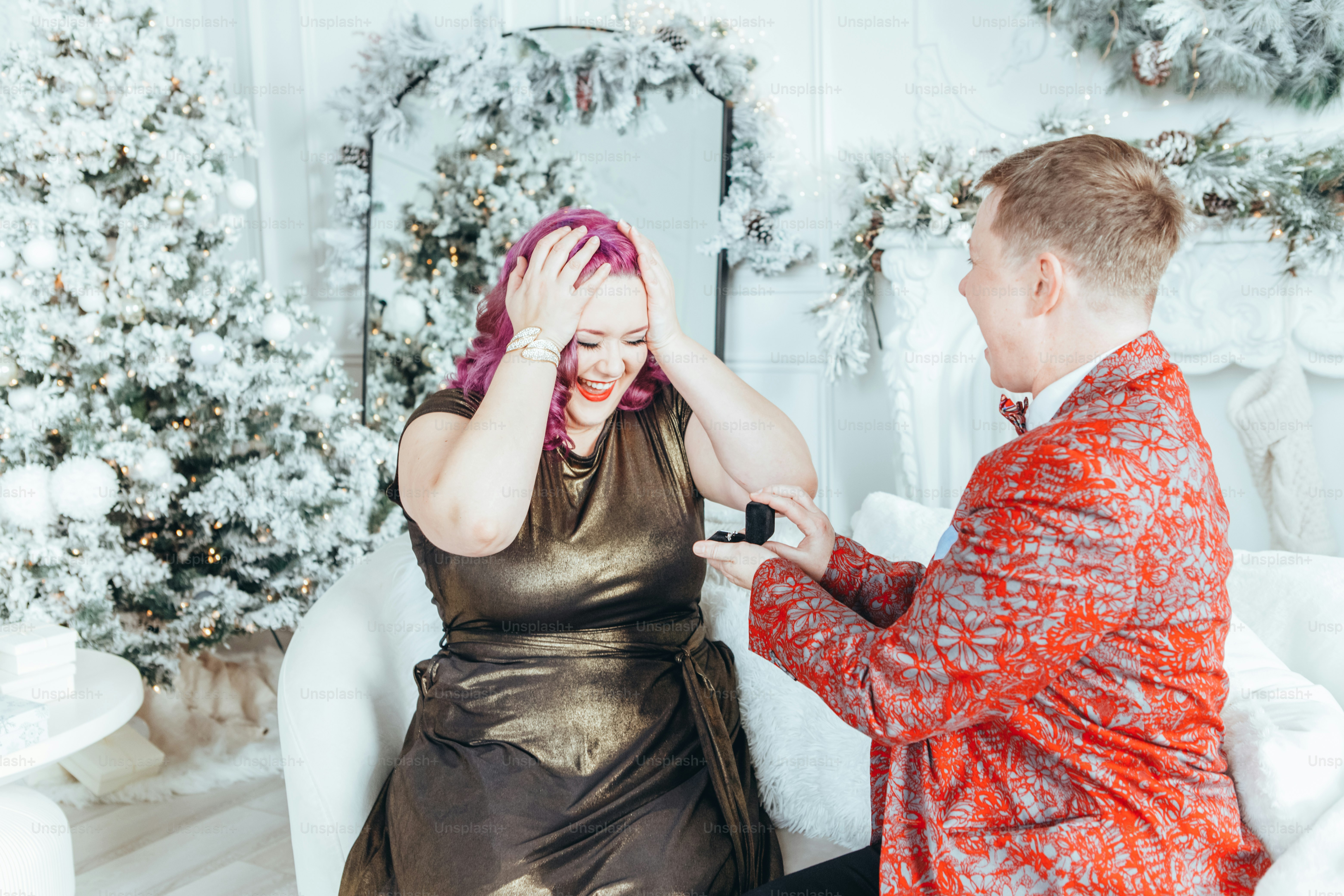 Homosexual gay butch woman proposing her girlfriend to marry her and giving her box with ring. LGBTQ lesbian couple celebrating Christmas or New Year winter holiday. Real authentic positive emotion