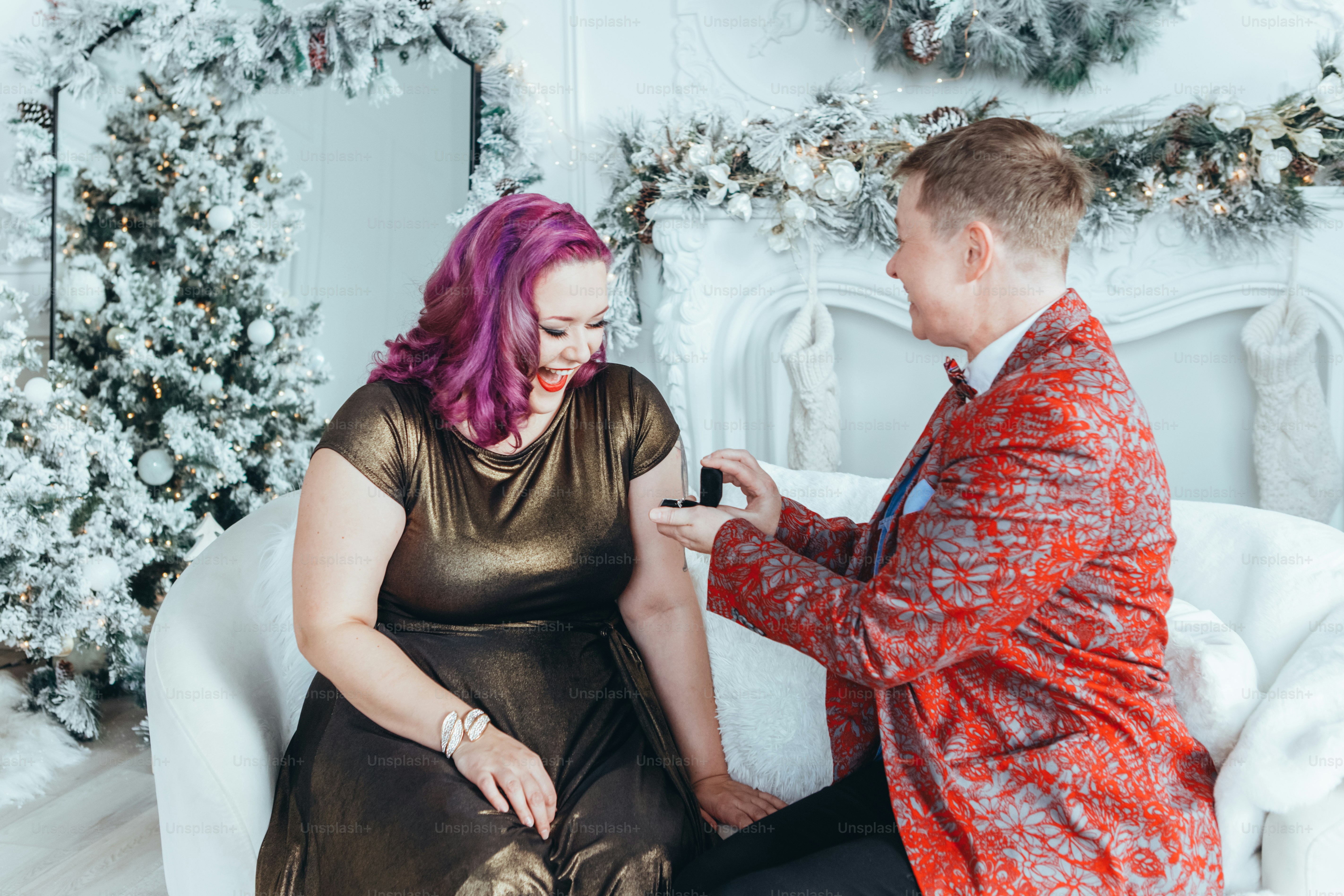Homosexual gay butch woman proposing her girlfriend to marry her and giving her box with ring. LGBTQ lesbian couple celebrating Christmas or New Year winter holiday. Real authentic positive emotion