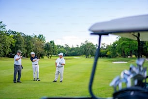 Group of Asian people businessman and senior CEO enjoy outdoor sport lifestyle golfing together at golf country club. Healthy men golfer shaking hand after finish talking business project and game on golf course