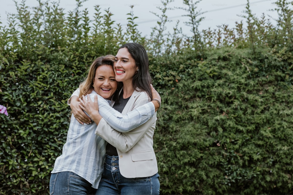 two latin women friends hugging at terrace office in Mexico Latin America