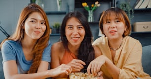 Attractive Asian lovely lady girl group positive glad cheerful with casual have fun and enjoy watch online movie entertainment on couch in living room at home.