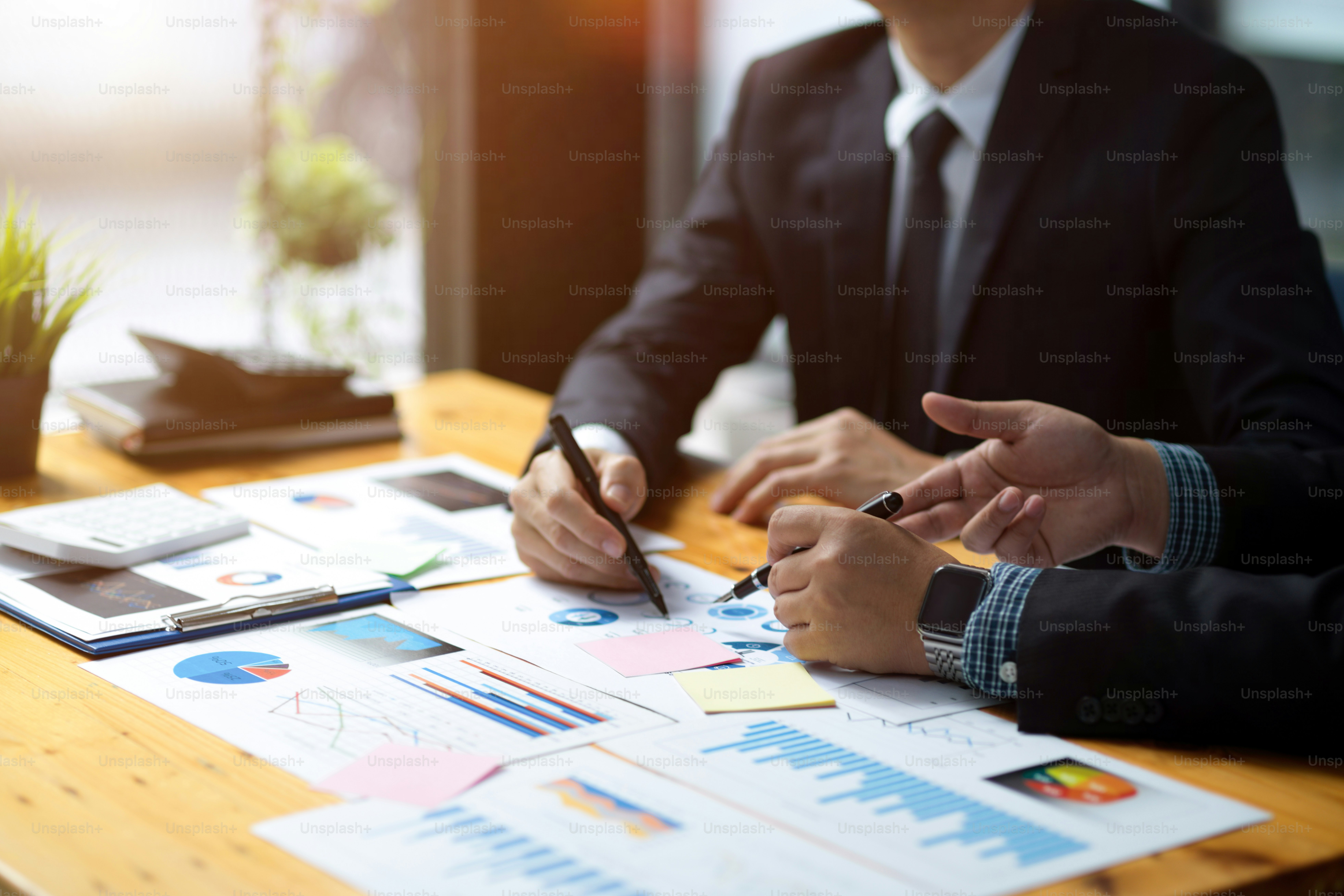 A group of financial analysts analysing and calculating project budget ...